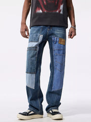 Men's relaxed fit jeans with distinctive blue denim patchwork and distressed details.