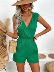 Green textured wrap-front romper with elastic waist and V-neck.