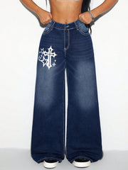 Dark wash cotton palazzo jeans with white cross and star graphic detail.