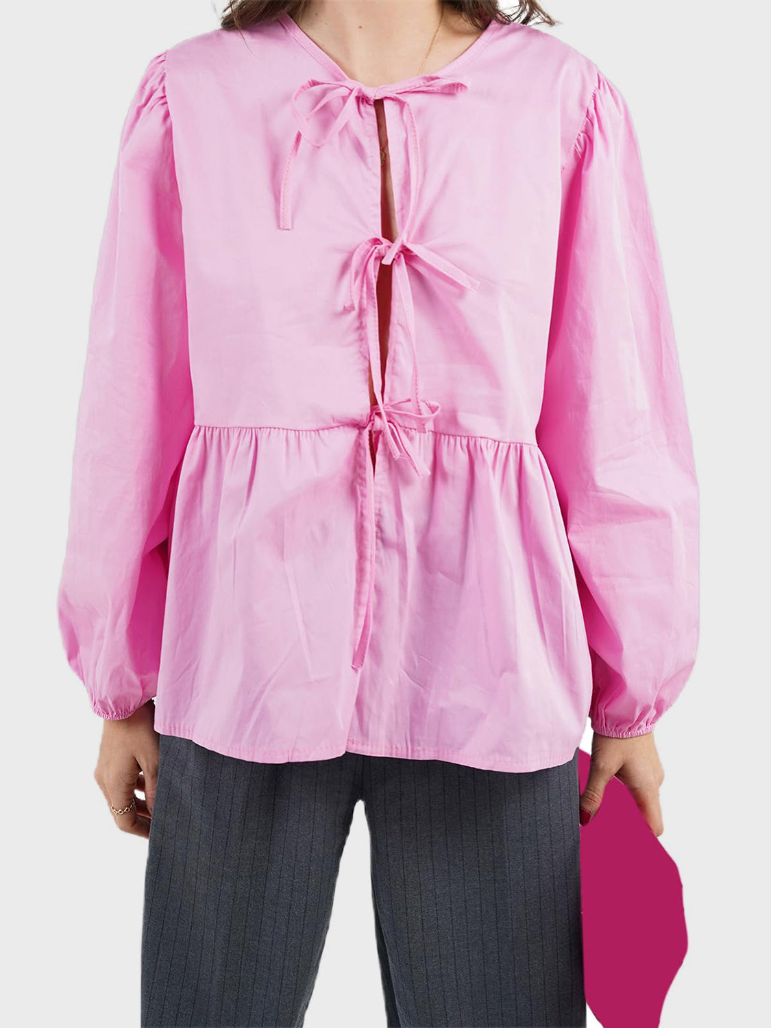 Pink tie-front peplum blouse with voluminous sleeves and tie detail