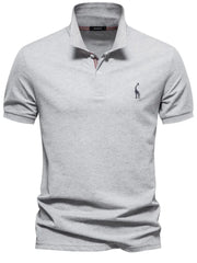 Gray piqué polo shirt with giraffe embroidery and striped collar detail.