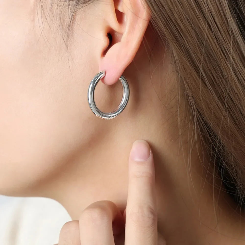 Sculpted silver hoop earrings with a polished finish.