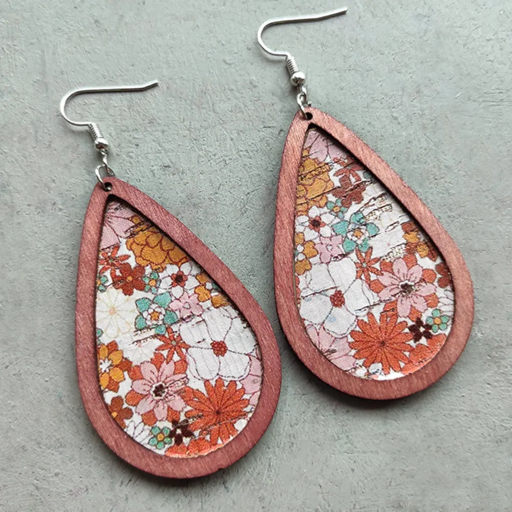 Floral teardrop woodgrain earrings in caramel with a vintage floral pattern.