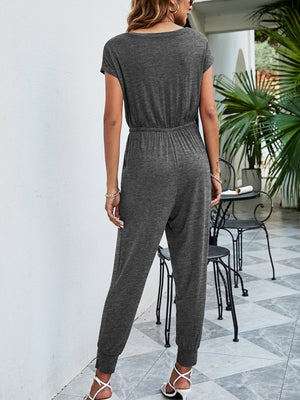 Dark gray jersey jumpsuit with drawstring waist, short sleeves, and cuffed ankles.