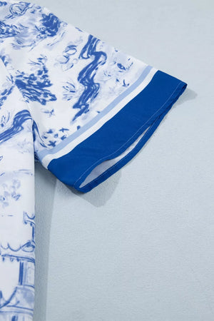 White polyester shirt with blue abstract print and striped cuffs.