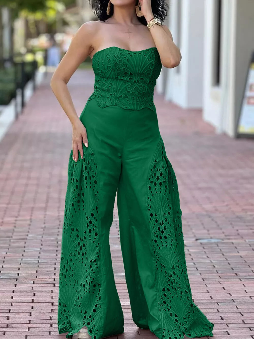 Green strapless two-piece ensemble with intricate openwork detailing on the bodice and wide-leg pants.