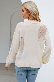 Cream knit sweater with open slit details on back and sleeves.