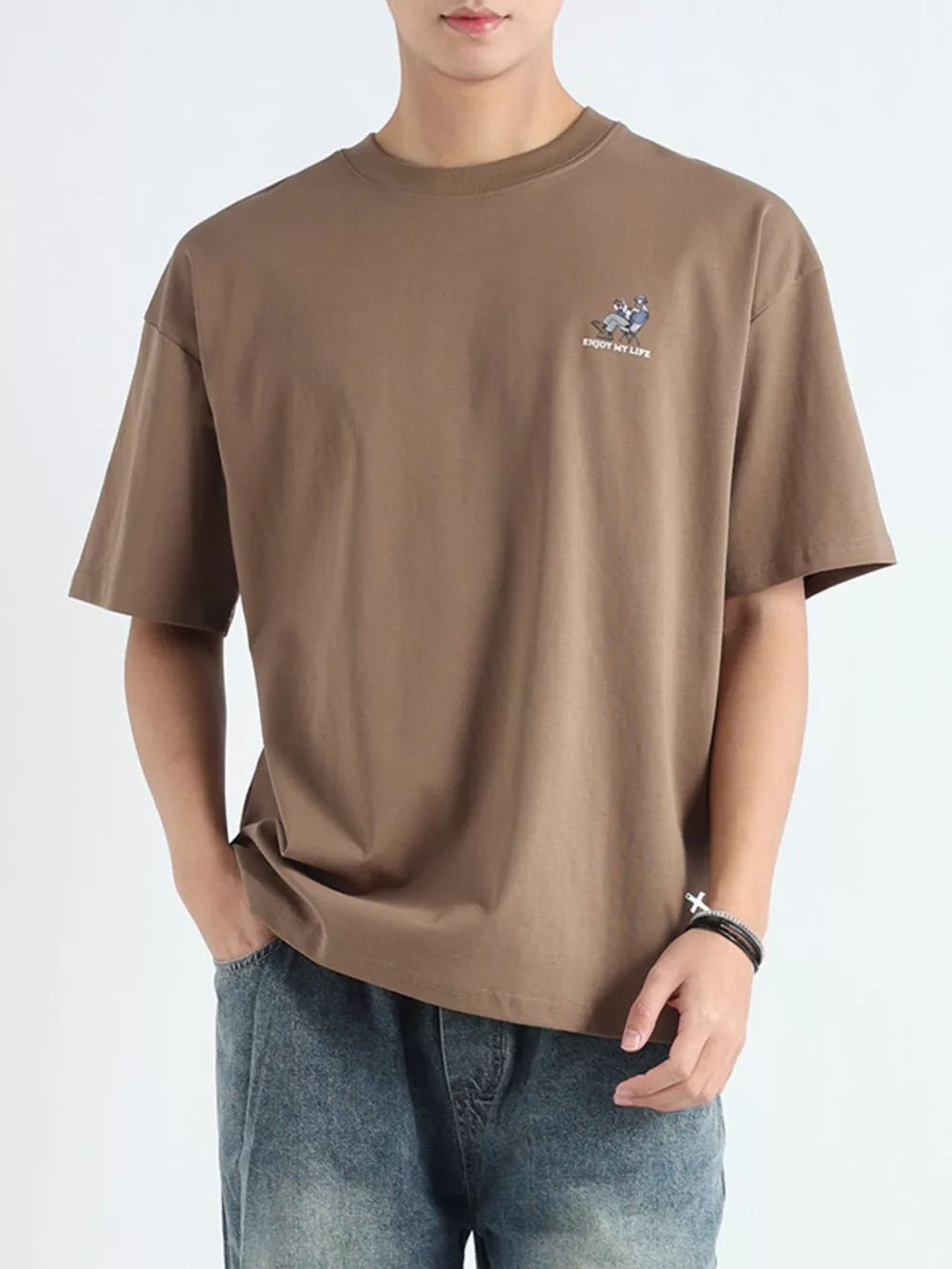 Men's relaxed fit graphic tee in Desert Color cotton with a small chest graphic and text.