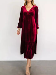 Burgundy velvet midi dress with V-neck, long sleeves, and tiered skirt.