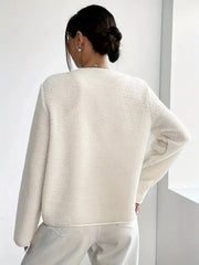 Ivory textured fleece button-up jacket with long sleeves.