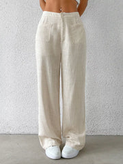 Wide-leg linen pants in beige with button closure and dual front patch pockets.