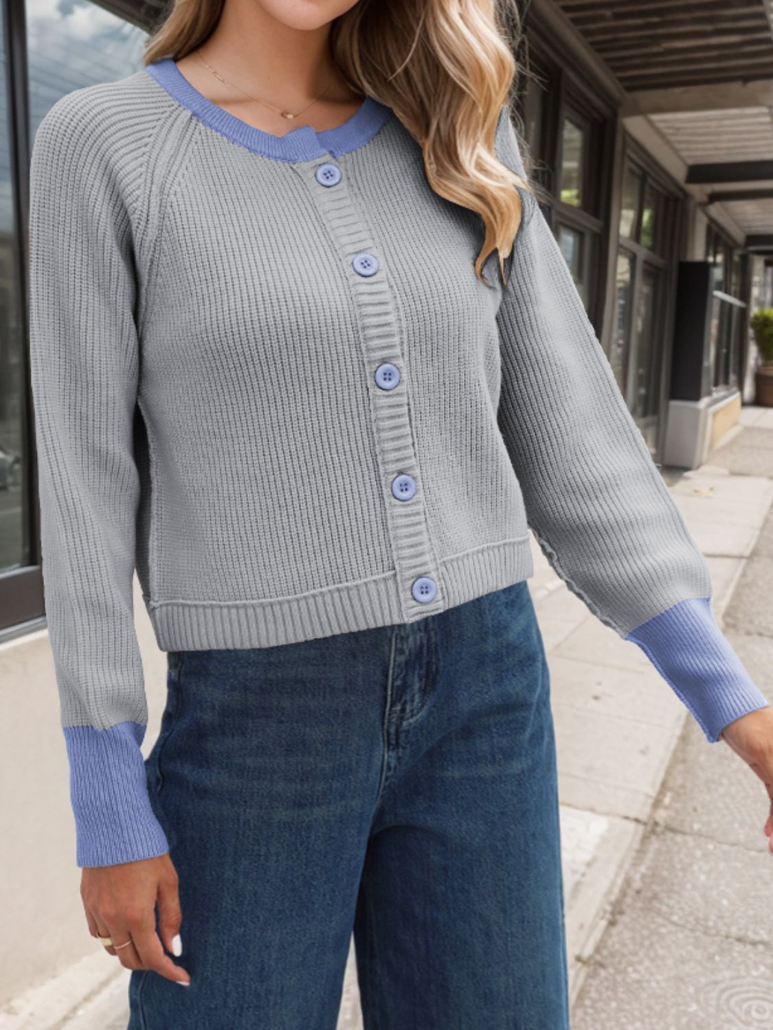 Gray raglan sleeve cardigan with blue trim and cuffs, button front, ribbed knit.