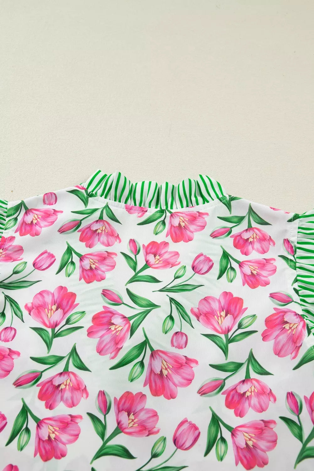 Tulip print polyester blouse with ruffled green striped neckline and sleeves.