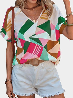 Geometric print V-neck blouse with short sleeves in multicolor.
