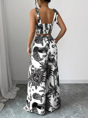 Black and white tropical print crop top and wide-leg pants set with tie straps.