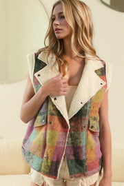 Multicolored plaid vest with sherpa collar and snap front, styled for a casual look.
