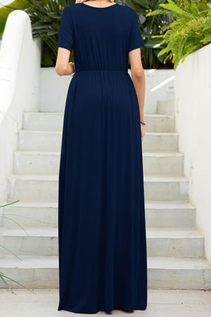 Navy gathered waist maxi dress with short sleeves and pockets, shown from the back.