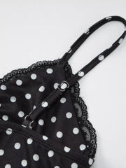 Black polka dot cami with white dots, lace trim, and adjustable straps.
