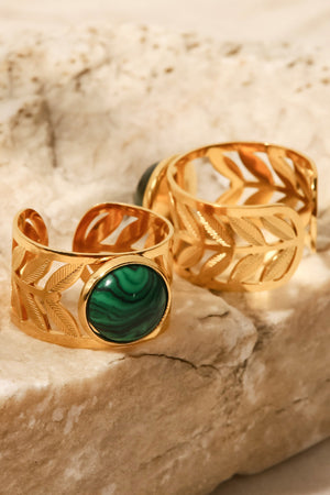 Leaf-cut gold ring with malachite stone and matching band ring.