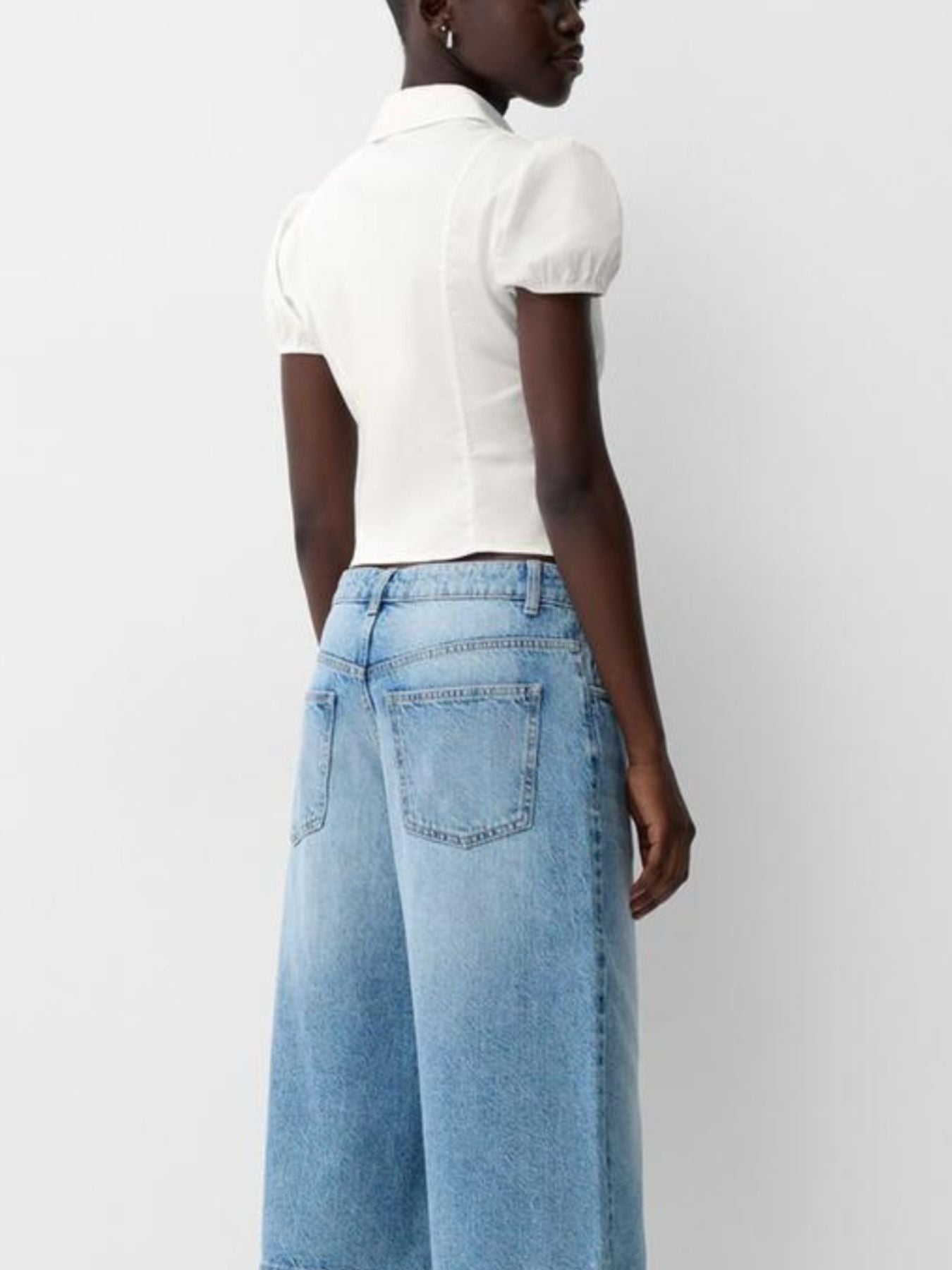 White maternity shirt with puff sleeves and gathered waist, button-up style