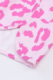 Pink leopard print shorts with scalloped hem detail