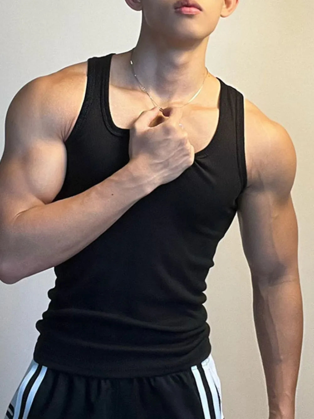 Black ribbed tank top with square neckline and racerback detail.