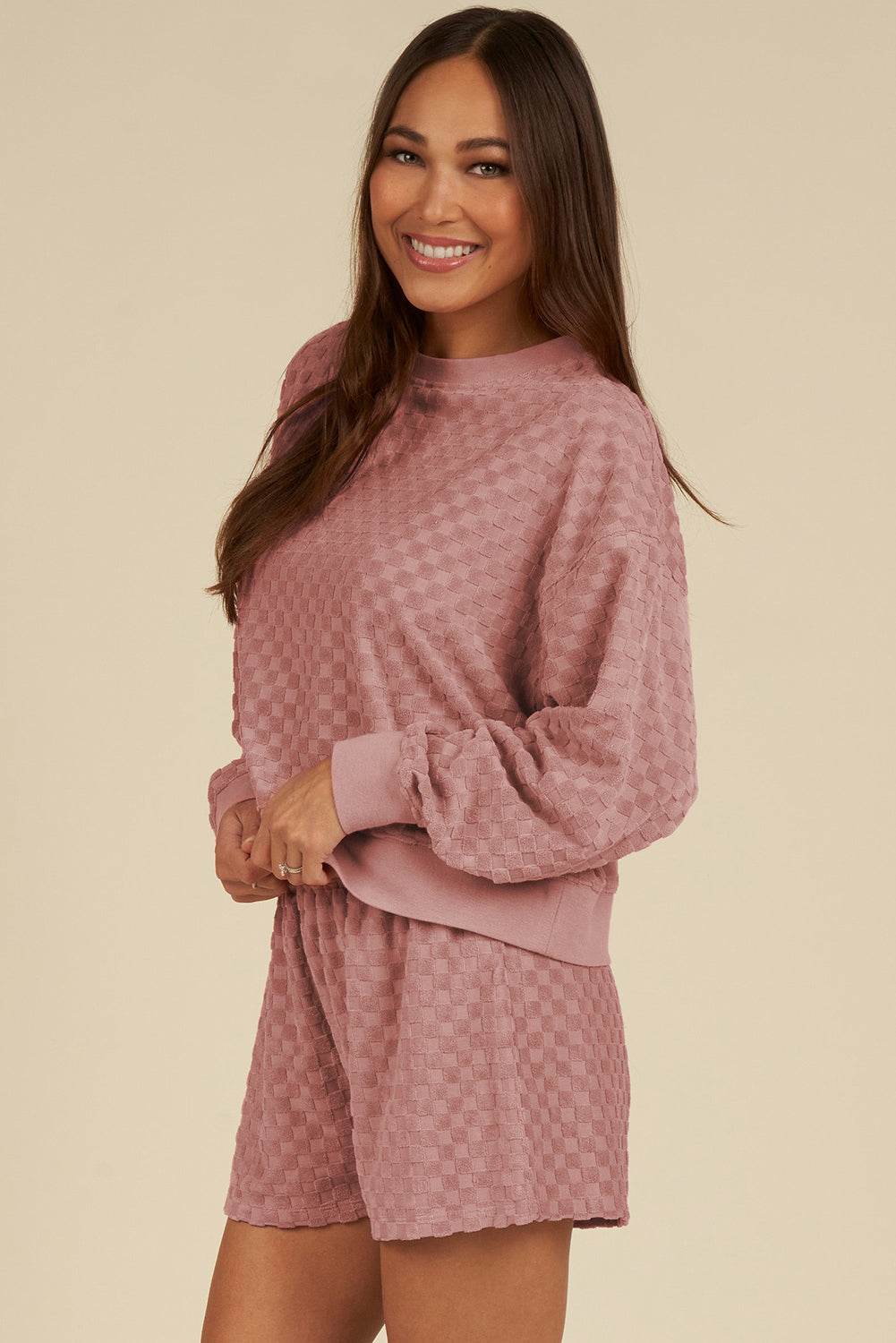 Dusty pink checkered textured lounge set with crew neck sweatshirt and shorts.