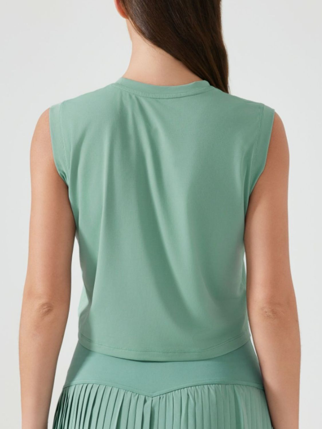 Sculpted crop active muscle tee in teal, sleeveless with crew neck.