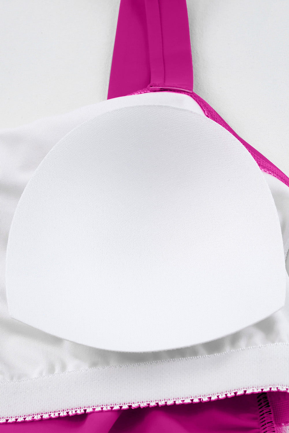 Sculpted tankini top in Cerise with white padded cups and decorative trim.