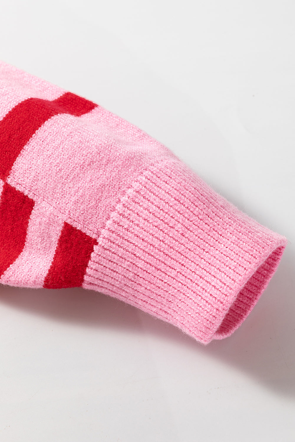 Colorblock stripe knit sweater in hot pink with red stripes and balloon sleeves.