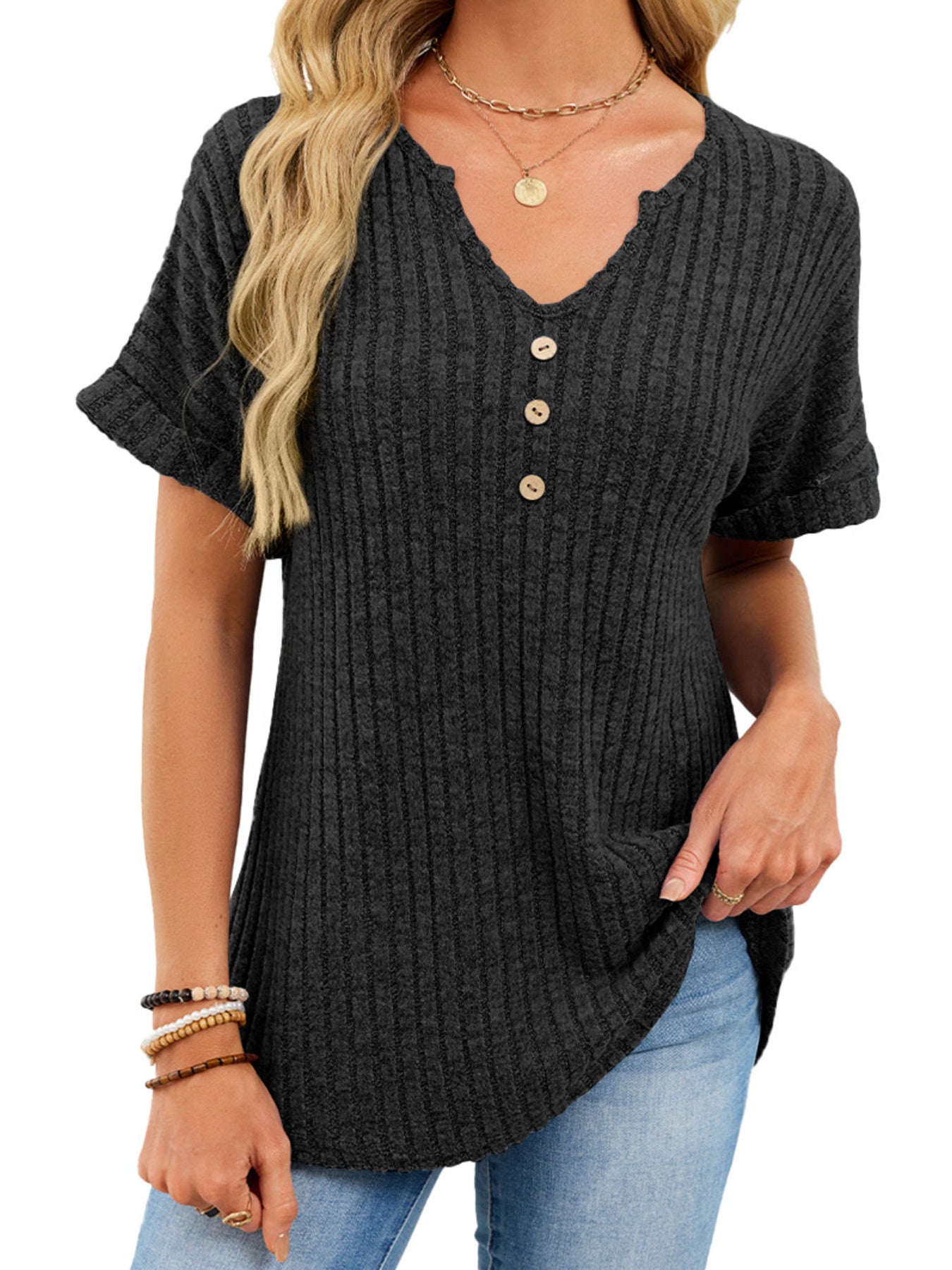 Black ribbed knit short sleeve t-shirt with v-neck and decorative buttons, curved hem.