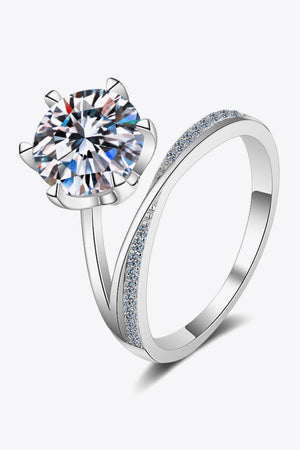Silver bypass ring with large solitaire diamond and pavé band.