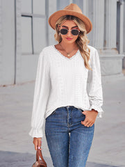 White eyelet blouse with lace trim neckline and ruffle cuffs.