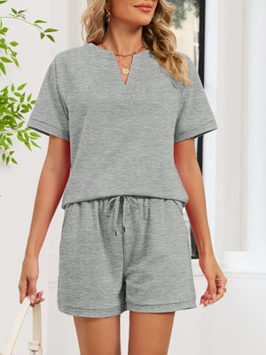 Gray two-piece loungewear set with drawstring shorts and a notched V-neck top.