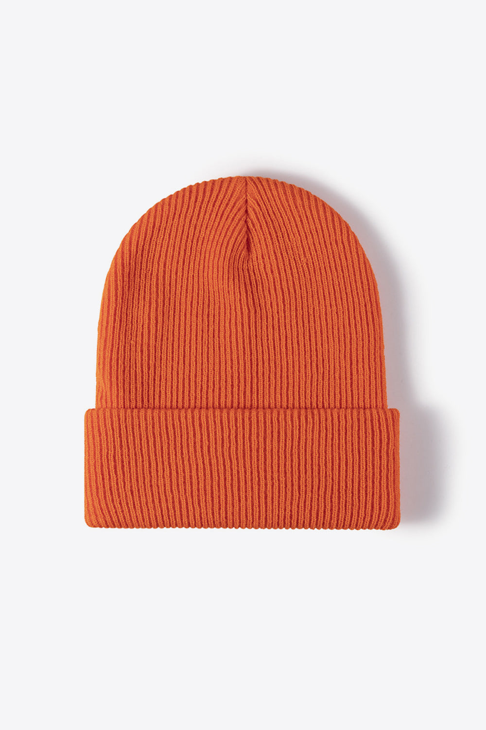 Ribbed knit beanie in tangerine acrylic with a cuffed brim.