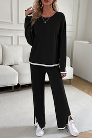 Black ribbed knit loungewear set with white trim on sleeves, hem, and pant cuffs.