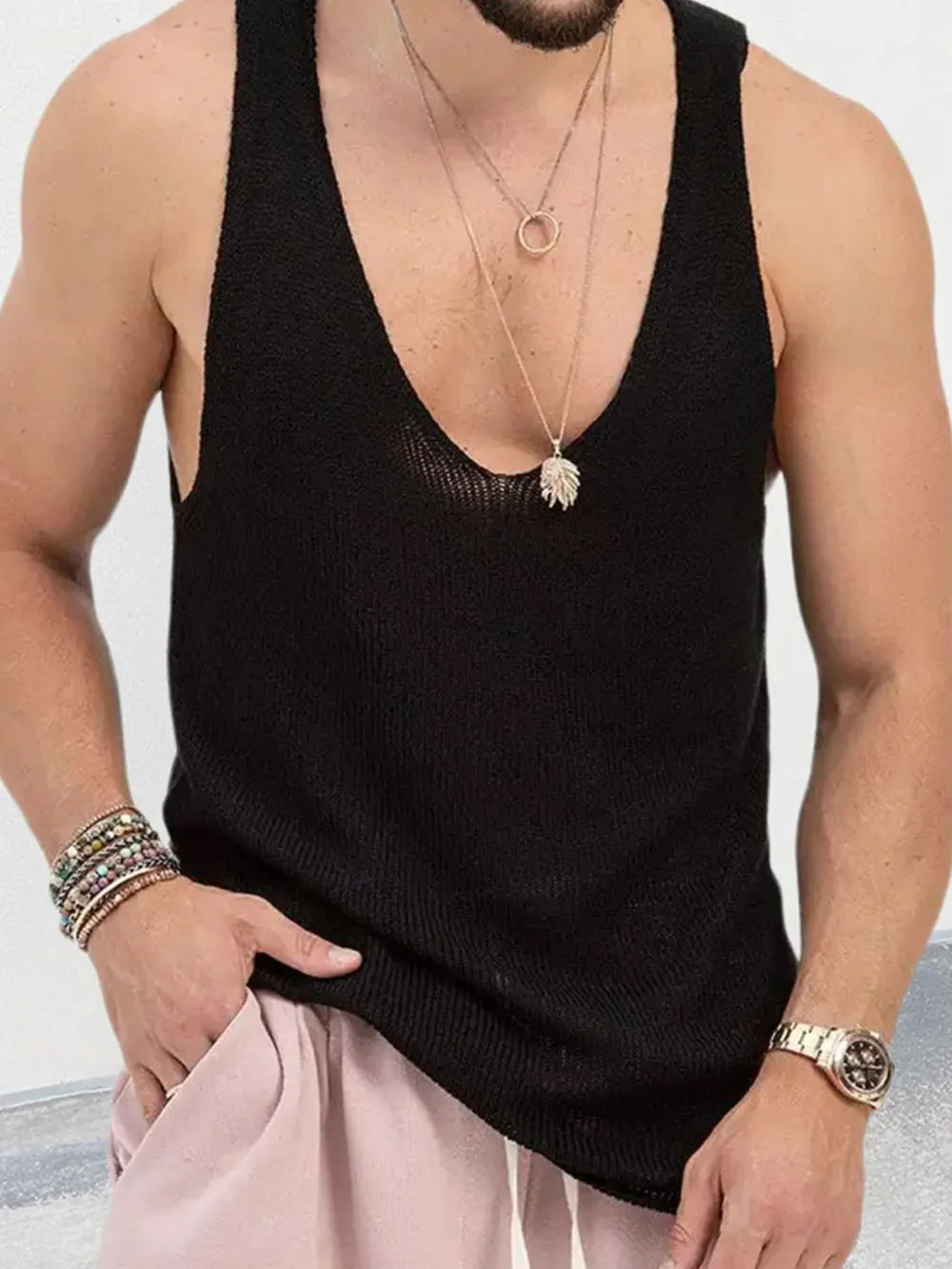 Black knit tank top with deep V-neck and sheer texture