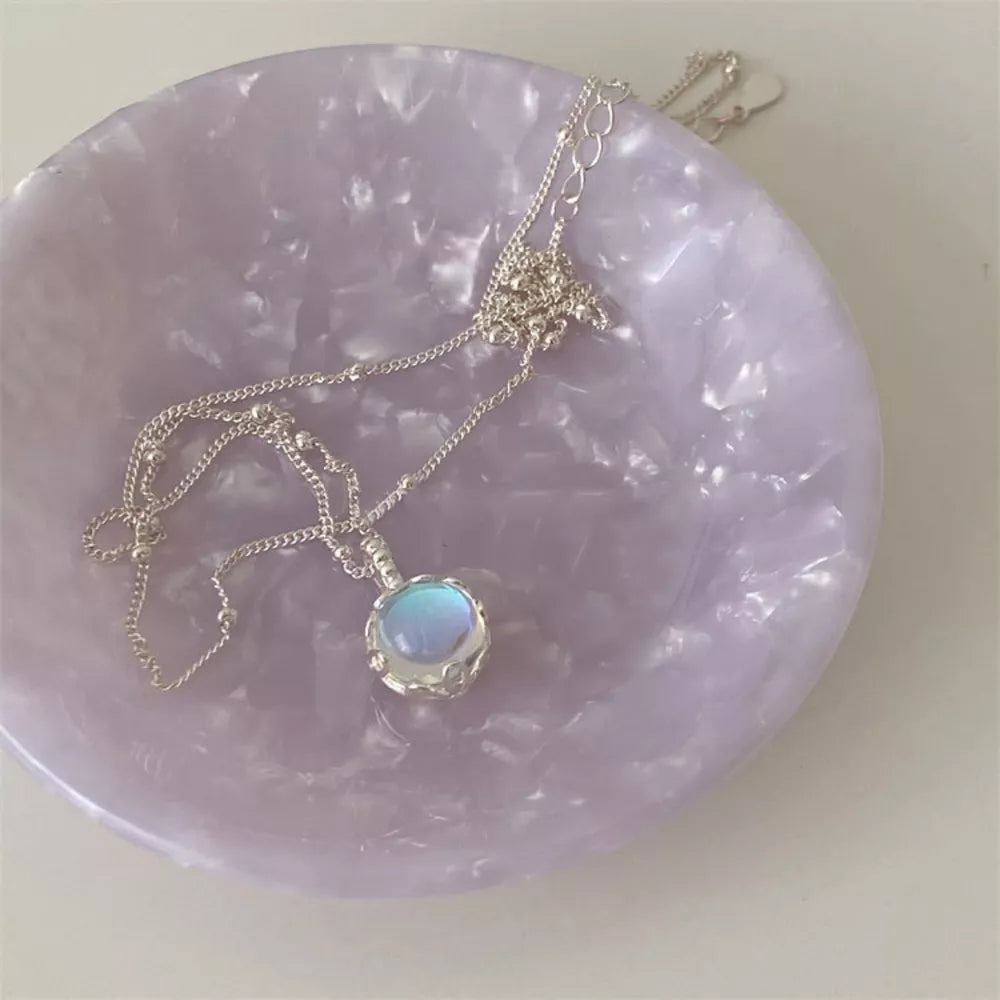 Luminous moonstone pendant necklace in 925 sterling silver with blue hues and delicate chain.