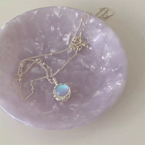 Luminous moonstone pendant necklace in 925 sterling silver with blue hues and delicate chain.