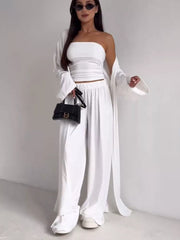 White three-piece maternity set with strapless crop top, wide-leg pants, and long cardigan.