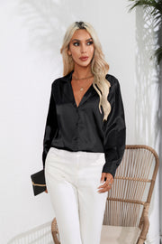 Black glossy satin button-down blouse with a V-neck and long sleeves.