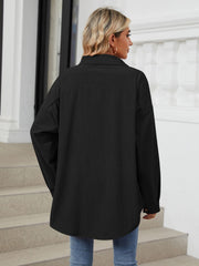 Black oversized corduroy shirt jacket with buttoned cuffs and a collar.