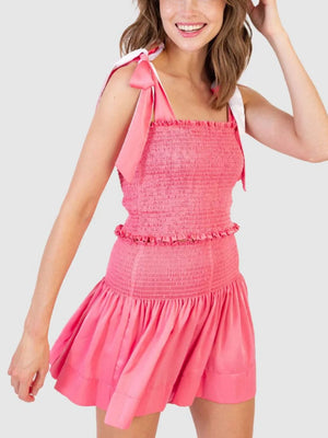 Smocked bodice and skirt set in strawberry pink with tie straps and ruffle trim.