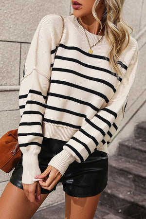 Beige and black striped boxy knit sweater with crew neck and long sleeves.