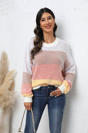 Horizontal stripe waffle knit pullover sweater in apricot and white with crew neck and long sleeves.
