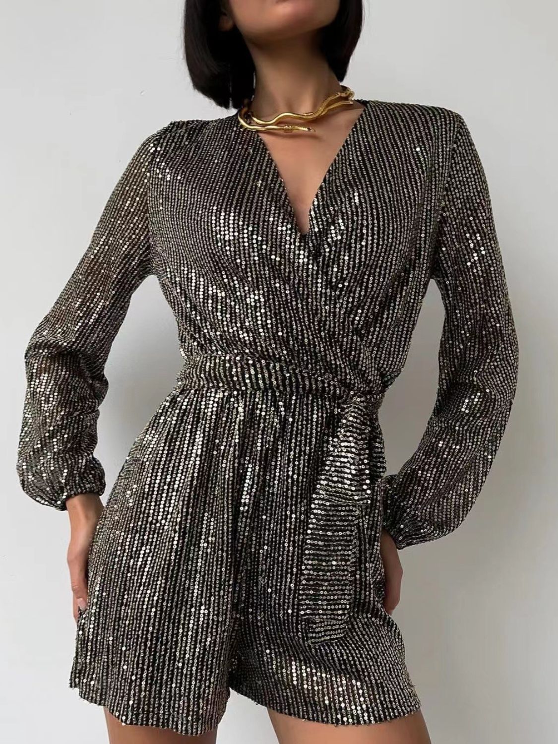 Sequin wrap romper in Black/Silver with blouson sleeves and a tie waist.
