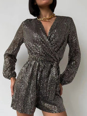 Sequin wrap romper in Black/Silver with blouson sleeves and a tie waist.