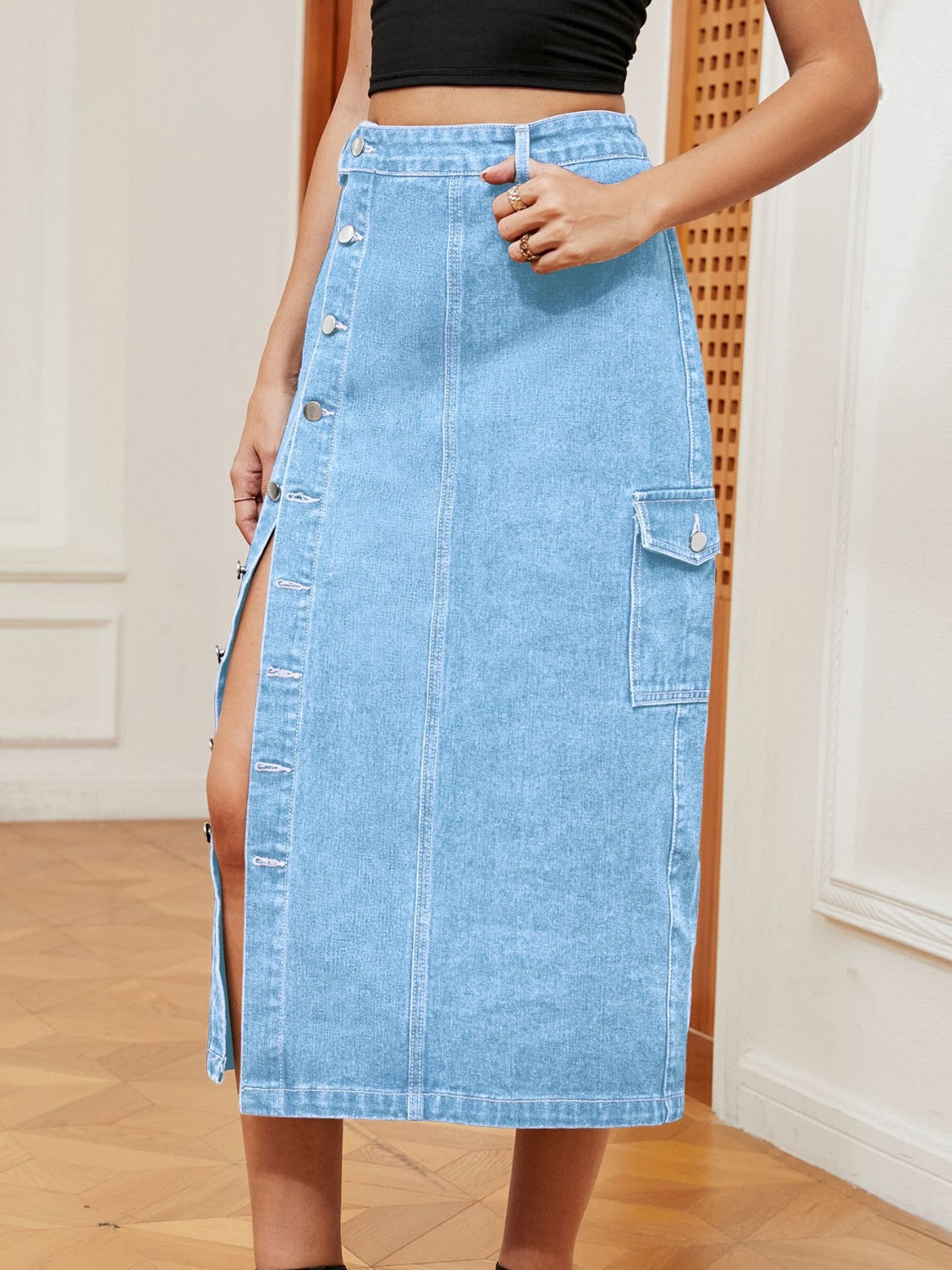 Light wash denim midi skirt with thigh slit and button front detail.