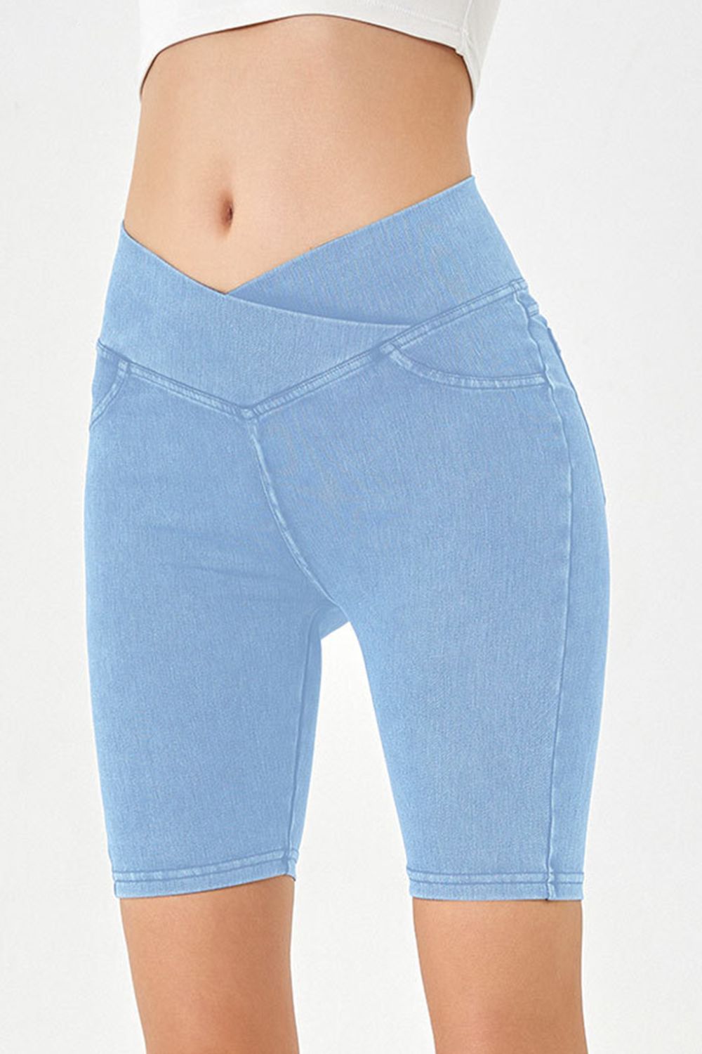 Light blue denim bermuda shorts with a crisscross waistband and a casual cut.