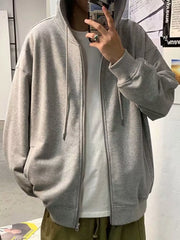 Gray casual zip-up hoodie with drawstring hood and pockets, worn over a white t-shirt.